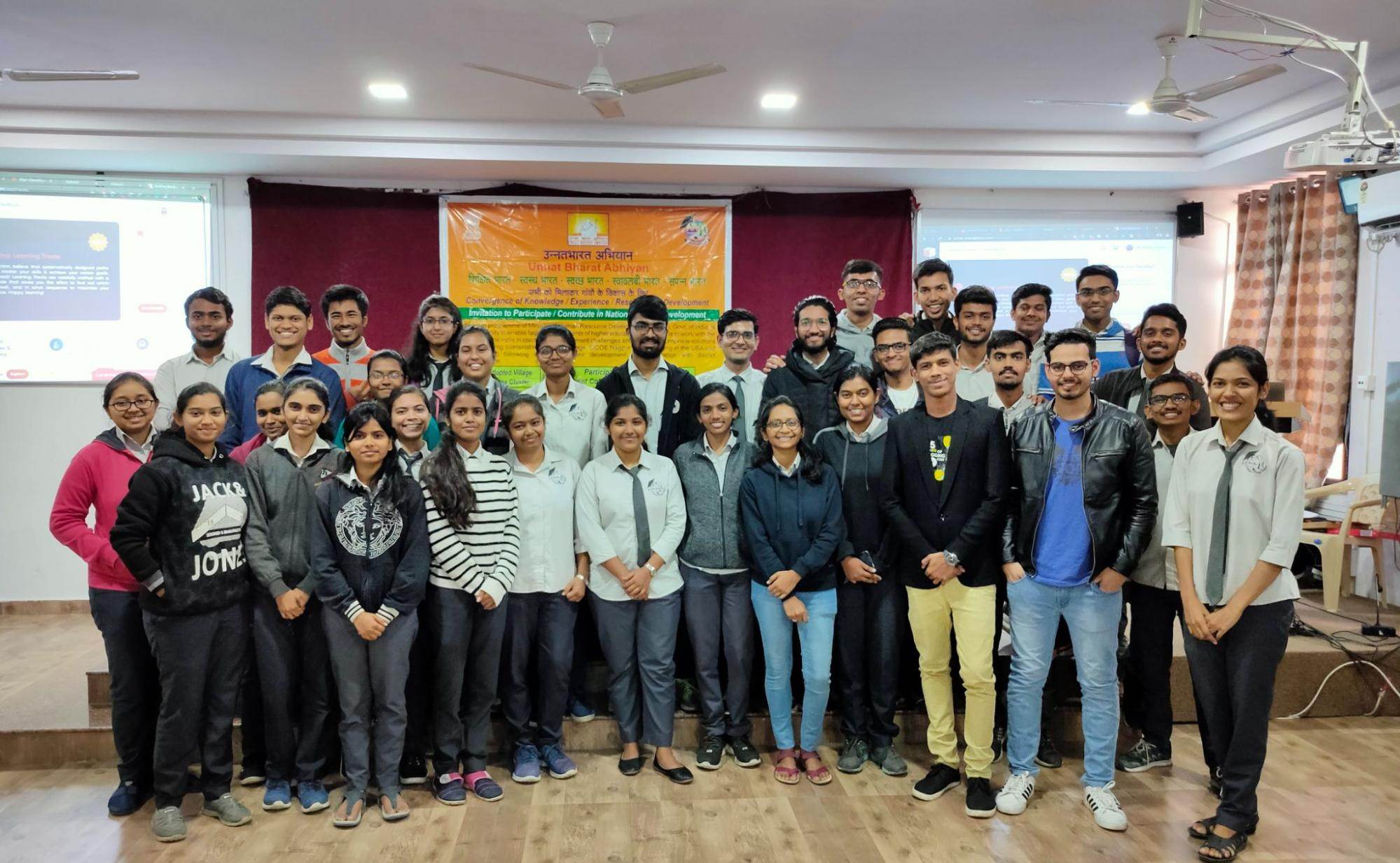 Me standing with an amazing group of students and developers, all smiles and ready to learn
